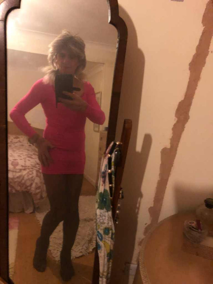 cross dresser wearing tights and short pink dress