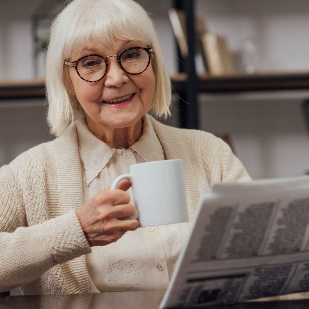 Elderly woman drinking a coffee