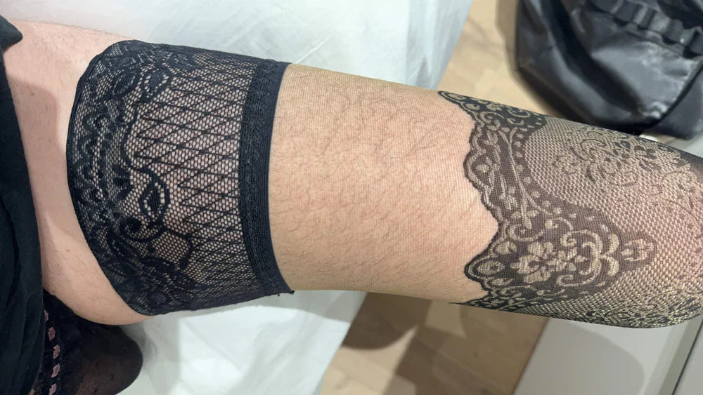 A MAN WEARING BLACK SHEER HOLD-UPS