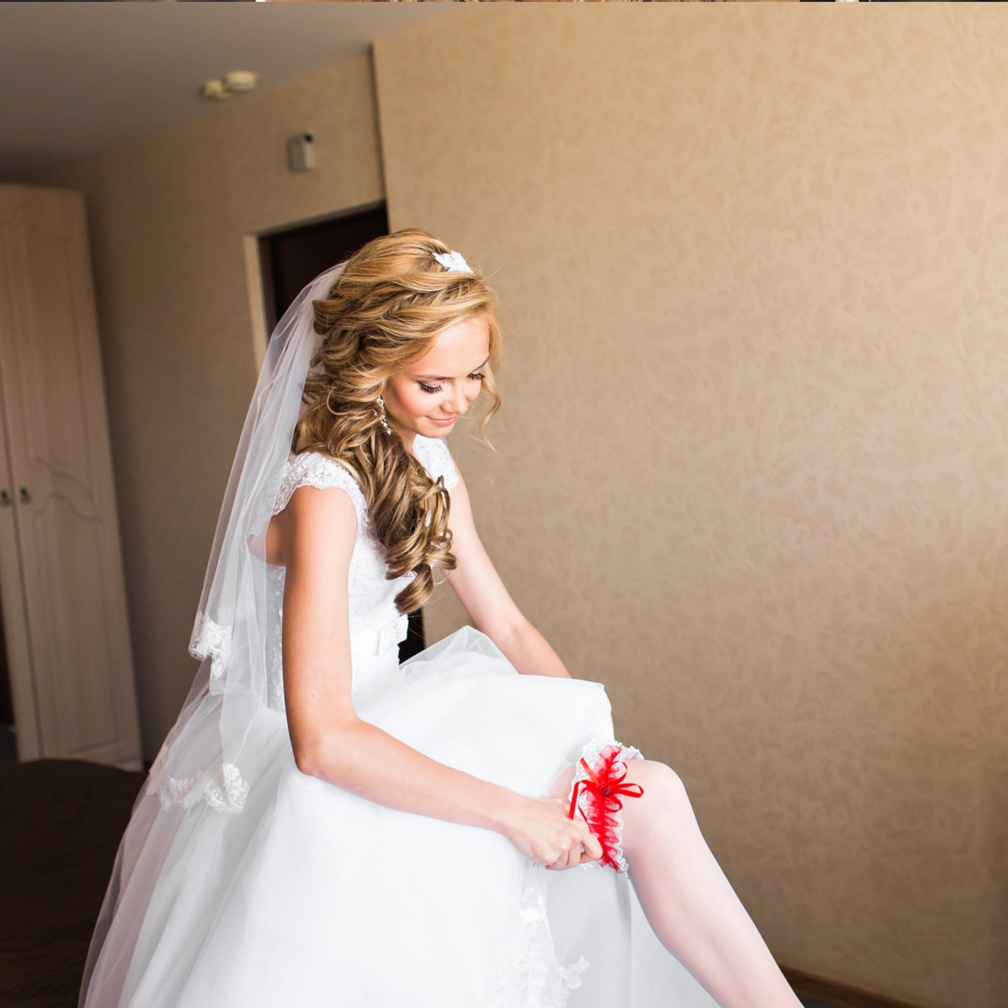 Woman wearing a wedding garter under her wedding dress